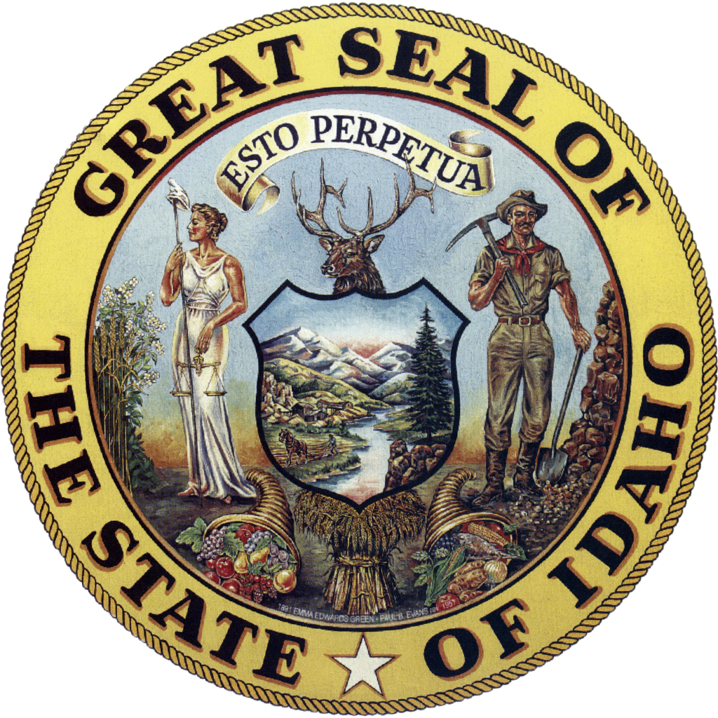 A round seal with the words Great Seal of the State of Idaho surrounding a painting of lady justice and a miner standing on either side of a shield painted with a landscape of mountains and rivers. Above the shield is the head of an elk with large antlers, and in front lay two cornucopias full of fruit and a bundle of hay.