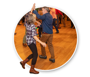 A group of people square dancing. The official state dance of Idaho.